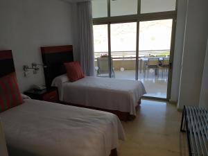 Voodi või voodid majutusasutuse Anfi del Mar Tauro Golf 1 Emerald Club toas