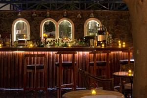 a bar in a restaurant with tables and chairs at Veggera Beach Hotel in Perissa