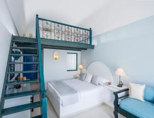 a bedroom with a bunk bed and a ladder at Veggera Beach Hotel in Perissa