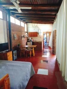 a living room with a bed and a dining room at Cabaña en Villa General Belgrano in Villa General Belgrano