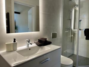 a bathroom with a sink, toilet and bathtub at Apartamenty Delecta in Kraków