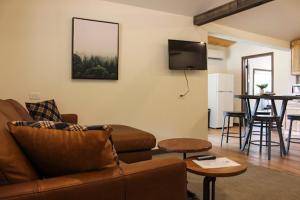 a living room with a couch and a table at Cabin 1 at Horse Creek Resort in Rapid City