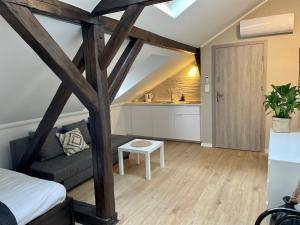 a living room with a bed and a kitchen at Apartamenty Delecta in Krakow