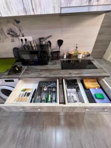 a kitchen with a drawer filled with food and utensils at GREEN THERAPY Self Check In in Yerevan