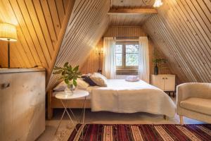 a bedroom with a bed and a window in a attic at Leśniczówka u Zięby in Kościelisko