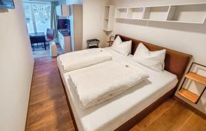 a bedroom with a large bed with white sheets and pillows at Arlberg-Schmiede in Wald am Arlberg