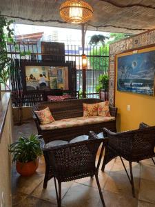 a living room with a couch and two chairs at Maré Praia Hotel in Fortaleza
