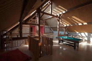 a room with a ping pong table in a building at B&B A l'Ombre du Tilleul in Aywaille