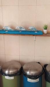 two trash cans sitting next to a counter with a shelf at Green House in Baleal