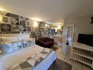 a bedroom with a bed and a living room at THE THATCH HIDE in East London