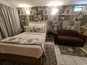 a bedroom with a bed and a chair at THE THATCH HIDE in East London +45 photos