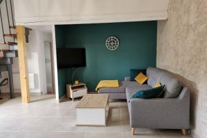 ein Wohnzimmer mit 2 Sofas und einem Flachbild-TV in der Unterkunft Ti ker 2 SPA in Plourin
