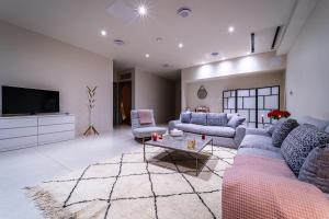 a living room with two couches and a tv at Kechmara hammam&spa in Lille