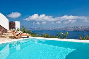 a swimming pool with a view of the water at Maison Des Lys - Luxury Suites in Akrotiri