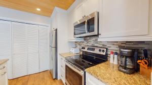 a kitchen with a stove and a microwave at 213 Turnberry Village in Hilton Head Island
