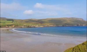 a view of a beach with mountains in the background at The moorings in Belmullet
