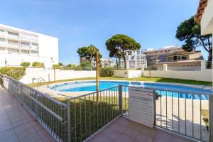 a swimming pool with a fence around it at Spacious 2bed family apartment in Puerto Marina in Benalmádena