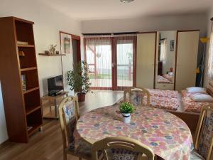 a living room with a table and a couch at Hellasz Apartman in Gyula +46 photos