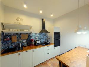 a kitchen with white cabinets and a counter top at Villa Akacja in Łeba