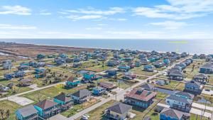 an aerial view of a residential neighborhood next to the ocean at Sea Glass Cottage in Crystal Beach