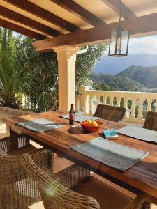 drewniany stół z krzesłami na patio w obiekcie Casa Sol with private terrace, garden, pool, beautiful view w mieście Port de Soller