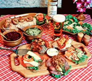 a table with many different types of food and beer at Stable Lodge - SHA Certified in Bangkok