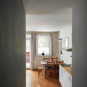 a kitchen and dining room with a table and chairs at Apartmán J+S Donovaly in Donovaly