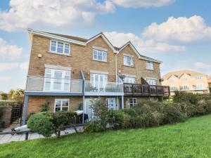 a large brick house with a balcony at Waters Edge in Weymouth