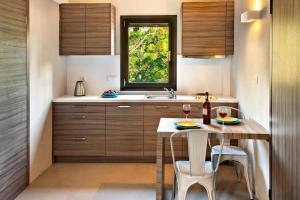 a kitchen with a table and chairs and a window at Apartments Sani Woods, Sani in Elani