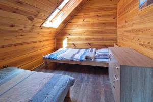 a bedroom with a bed in a wooden cabin at Semi-detached house, Niechorze in Niechorze