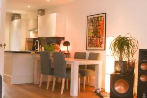 a kitchen with a table and chairs in a room at Beautiful quiet family-apartment near The Hague in Rijswijk