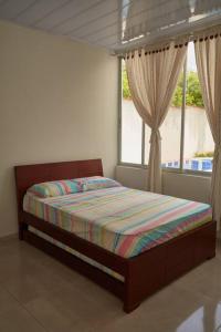 A bed or beds in a room at Casa vacacional Girardot 5 habit