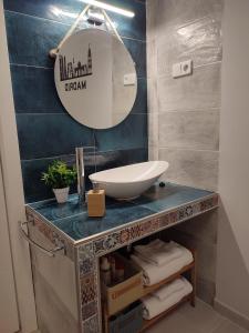 a bathroom with a sink and a mirror on a counter at Estudio Madrid Norte 2 in Madrid