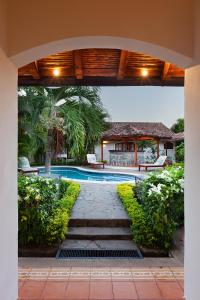 an archway leading to a swimming pool in a villa at Hotel Boutique Adela in Granada