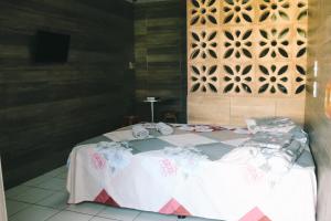a bedroom with a bed in a room with a wall at VIP Ponta Verde in Maceió