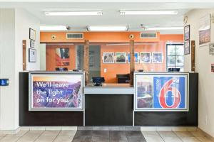 a waiting room with a counter with a sign at Studio 6 Tucson, AZ - North in Tucson +45 photos
