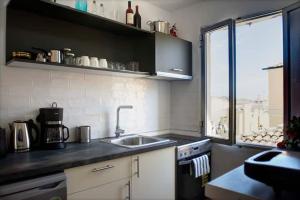 a small kitchen with a sink and a window at Casa di Roza in Corfu +7 photos