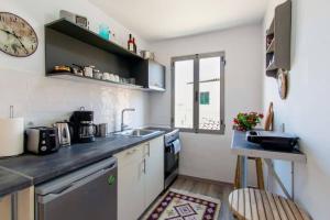 a kitchen with a sink and a counter top at Casa di Roza in Corfu