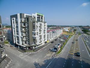 an aerial view of a city street with a tall building at Manhattan Hotel Ipoh in Ipoh