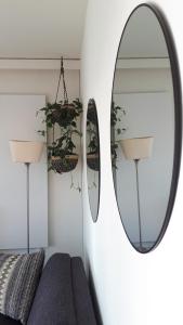 a living room with a mirror and a couch at 9 High (in the Sky) in De Panne