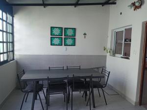 a dining room with a table and chairs at Casa Termas in Termas de Río Hondo