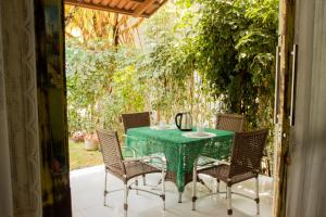 皮帕Bangalô Pipa Resort的天井上摆放着绿色的桌椅