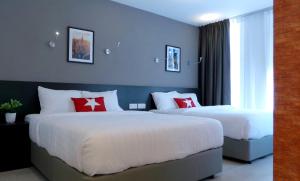 a hotel room with two beds and a window at Manhattan Hotel Ipoh in Ipoh +83 photos