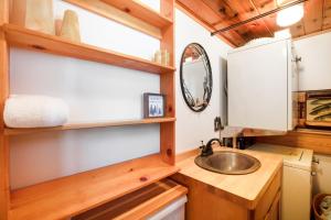 a bathroom with a sink and a mirror at The Valley's Cabin in Green Valley Lake +16 photos