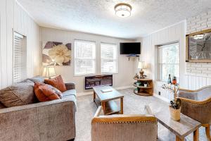 a living room with a couch and a fireplace at Squirrels Nest in Asheville