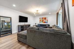 a living room with a couch and a flat screen tv at Cold Drinks Hot Nights in Scottsdale