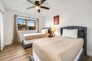 a bedroom with two beds and a ceiling fan at Cold Drinks Hot Nights in Scottsdale