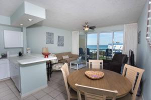 a kitchen and dining room with a table and a kitchen and a living room at Destin West Beach Resort #609-1Br/2Ba-Sleeps 6 in Fort Walton Beach