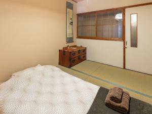 Postel nebo postele na pokoji v ubytování Yukari Shijo Kyoto