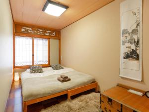 Postel nebo postele na pokoji v ubytování Yukari Shijo Kyoto